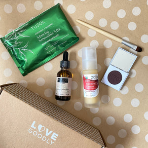 Cosmetic products and packaging on a polka dot background with 'Love Goodly' branding.